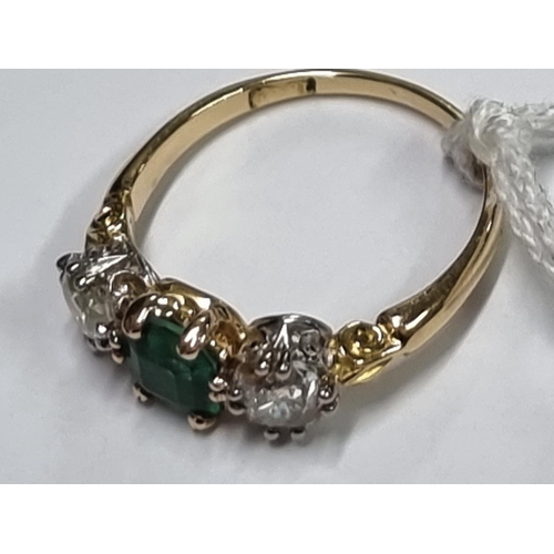 684 - A yellow metal emerald doublet and diamond three stone ring, stamped 18ct, size O.