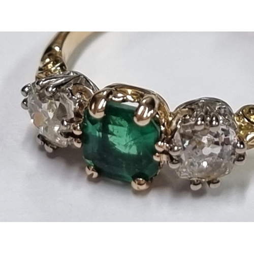 684 - A yellow metal emerald doublet and diamond three stone ring, stamped 18ct, size O.