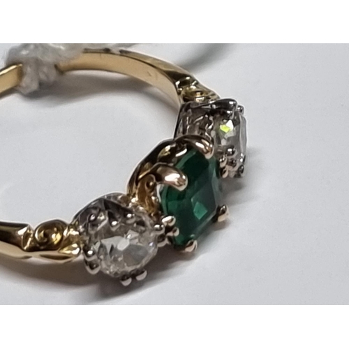 684 - A yellow metal emerald doublet and diamond three stone ring, stamped 18ct, size O.