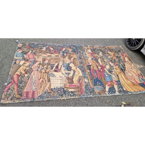 1081 - A tapestry wall hanging, depicting medieval figures making wine, 270 x 145cm.