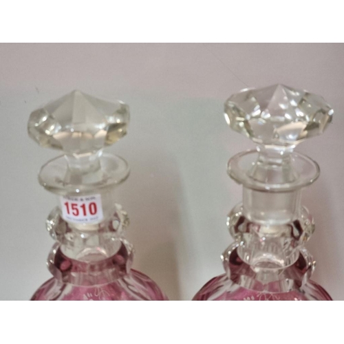 1401 - A good pair of cranberry flashed cut glass decanters and stoppers, 30.5cm high; together with a cran... 