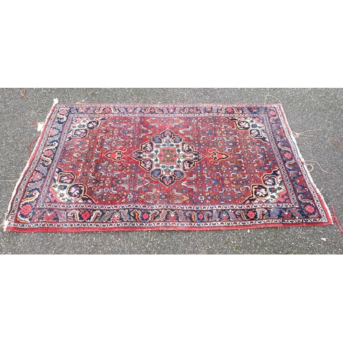 1001 - A Persian red ground rug, 217.5 x 124.5cm.