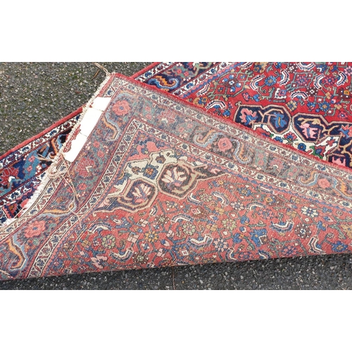 1001 - A Persian red ground rug, 217.5 x 124.5cm.