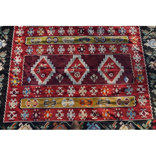 1006 - WITHDRAWN FROM SALE A Caucasian flatweave rug, having nine diamond medallions to central field, with... 