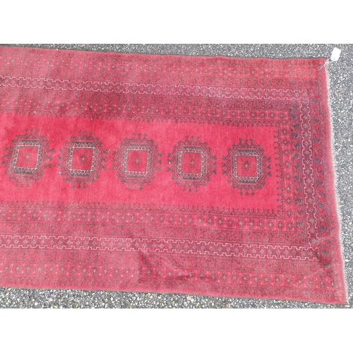 1008 - A Persian red ground rug, 207 x 110cm.