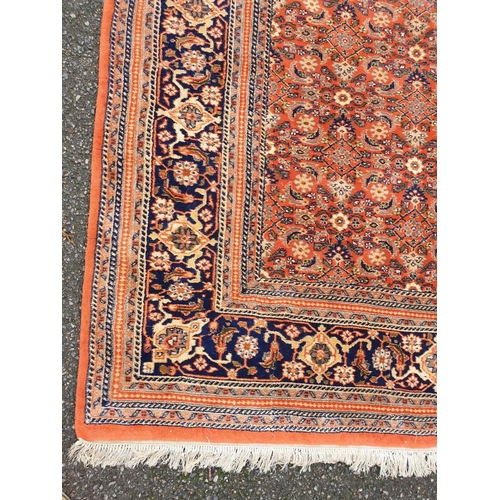 1010 - A Persian coral ground carpet, 282 x 254cm.