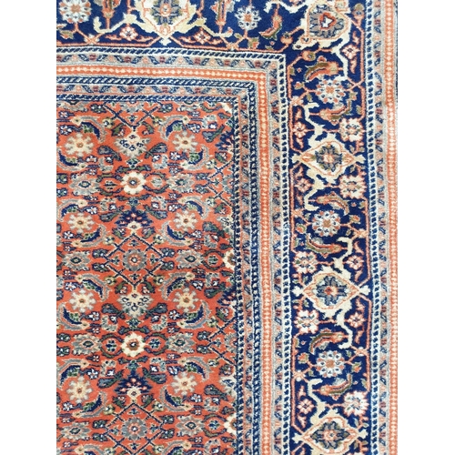 1010 - A Persian coral ground carpet, 282 x 254cm.