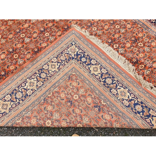 1010 - A Persian coral ground carpet, 282 x 254cm.