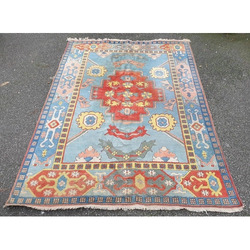 1011 - A large Turkish pale blue ground carpet, 320 x 237cm, (some staining).