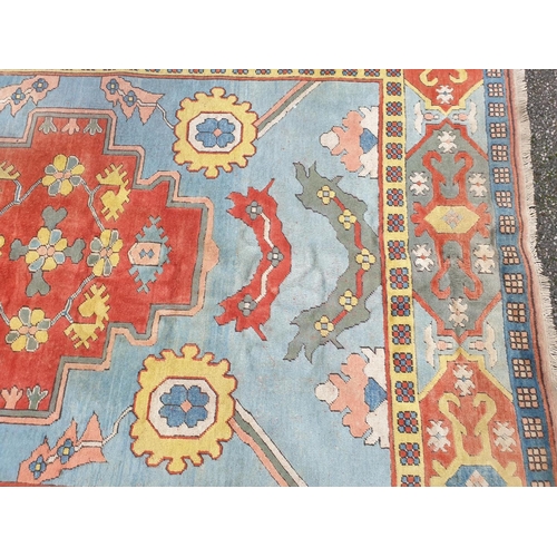 1011 - A large Turkish pale blue ground carpet, 320 x 237cm, (some staining).