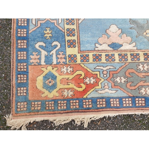 1011 - A large Turkish pale blue ground carpet, 320 x 237cm, (some staining).