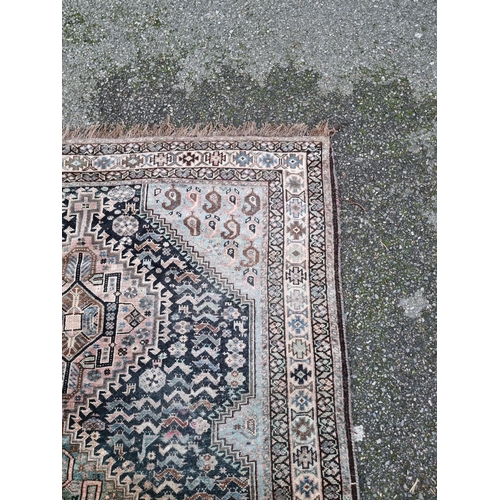 1016 - A Persian rug, having three central diamond medallions, central field decorated with geometric desig... 