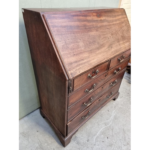 1024 - A George III mahogany bureau, 97cm wide.