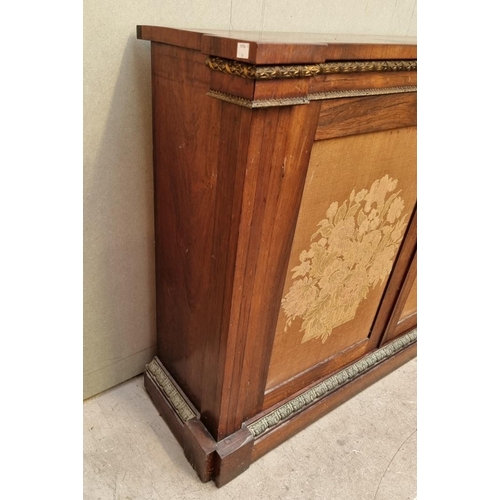 1030 - A George IV rosewood and gilt brass side cabinet, with fabric panel doors, 132.5cm wide.... 