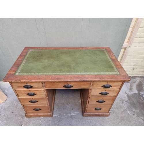 1035 - An antique pitch pine pedestal desk, 122cm wide. 