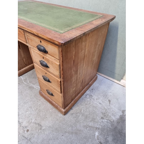 1035 - An antique pitch pine pedestal desk, 122cm wide. 