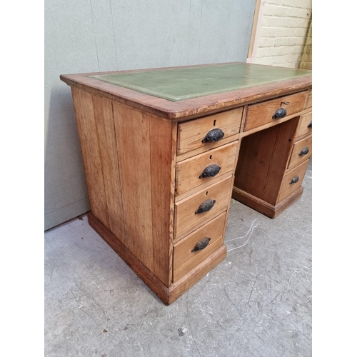 1035 - An antique pitch pine pedestal desk, 122cm wide. 