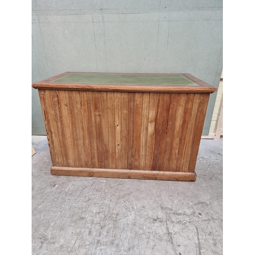 1035 - An antique pitch pine pedestal desk, 122cm wide. 