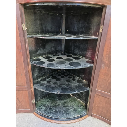 1036 - A George III mahogany and inlaid bowfront hanging corner cupboard, 119 x 78cm.