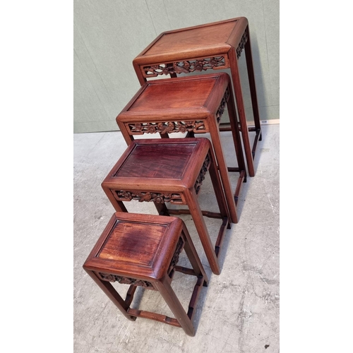 1053 - A set of four Chinese carved hardwood quartetto tables, largest 46cm wide.