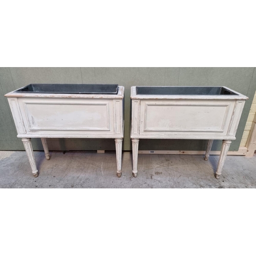 1065 - A pair of Louis XVI style white painted rectangular jardinieres, 66cm wide.