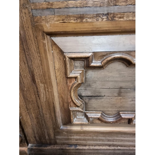 1070 - An antique Continental walnut and oak side cabinet, with moulded decoration, 119cm wide.... 