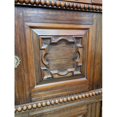 1070 - An antique Continental walnut and oak side cabinet, with moulded decoration, 119cm wide.... 