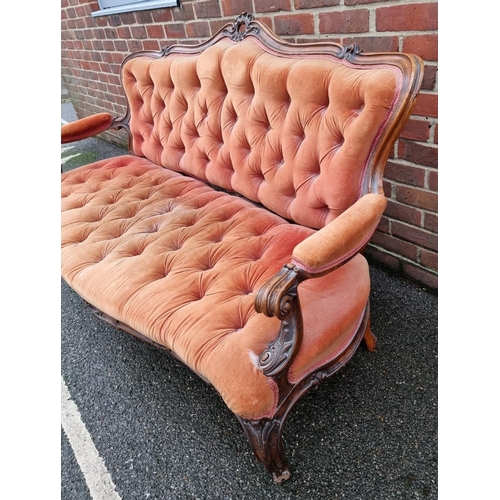 1088 - A Victorian carved walnut and button upholstered settee, (faults).