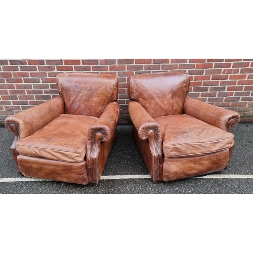 1089 - A pair of brown leather club chairs. 