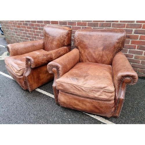 1089 - A pair of brown leather club chairs. 