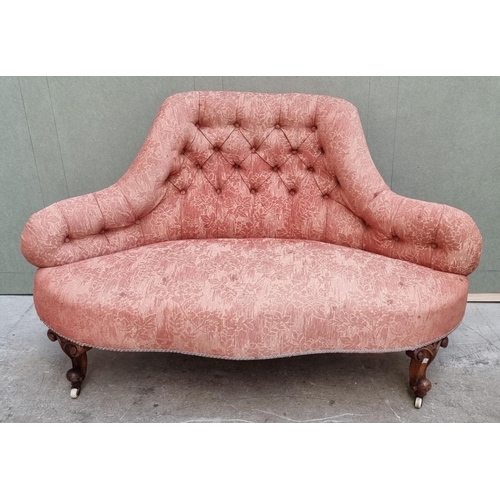 1090 - A small Victorian walnut and button upholstered settee, 135cm wide.