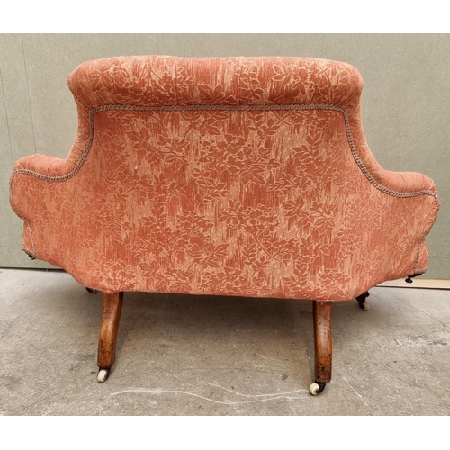 1090 - A small Victorian walnut and button upholstered settee, 135cm wide.