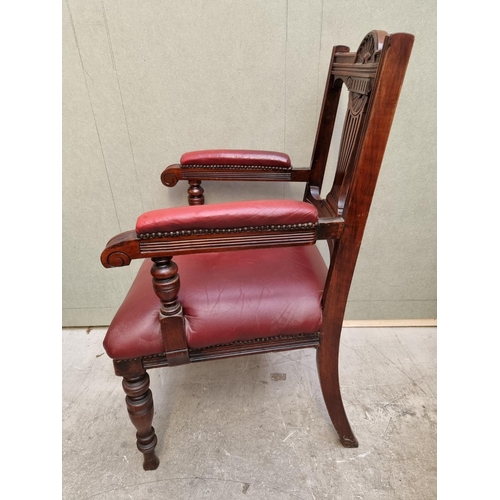 1092 - A good circa 1900 carved mahogany and red leather desk chair. 