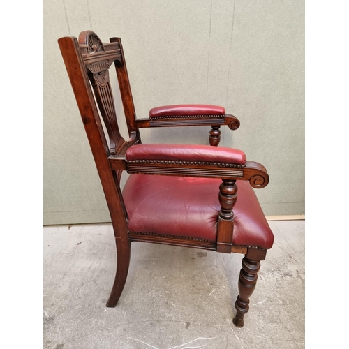 1092 - A good circa 1900 carved mahogany and red leather desk chair. 