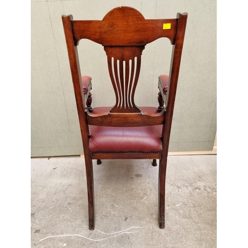 1092 - A good circa 1900 carved mahogany and red leather desk chair. 