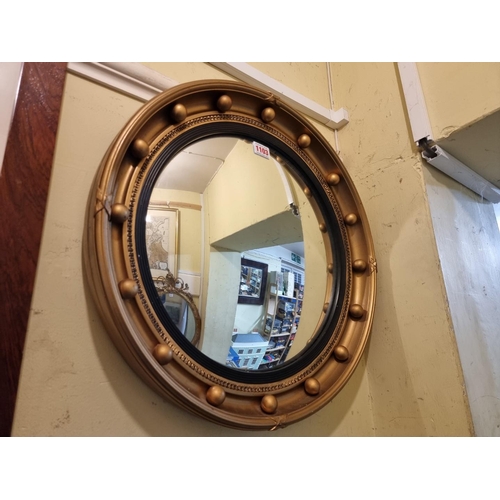 1103 - A vintage gilt convex wall mirror, labelled of 'Aisonea', 47cm diameter.