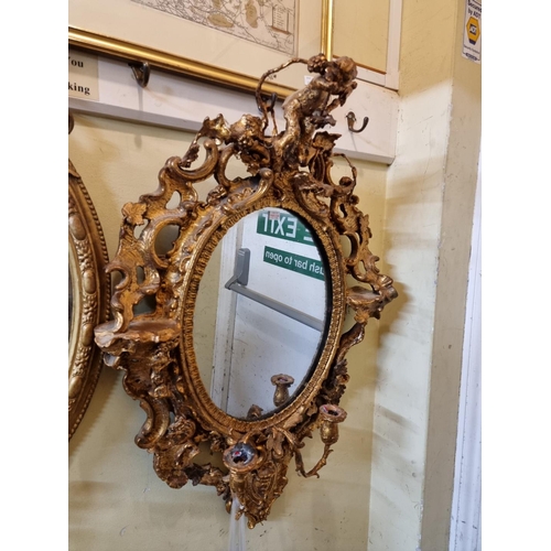 1105 - Two antique giltwood framed girandoles, largest 100 x 56cm.