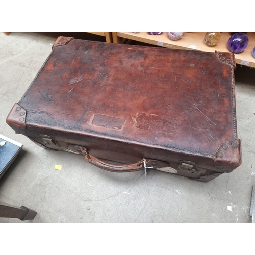 1157 - A vintage tan leather suitcase, labelled 'Hercules Make', 62cm wide. 