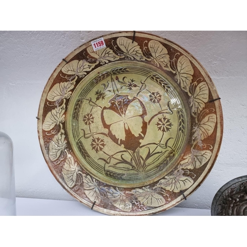 1159 - A 19th century Continental slip glazed charger, 44cm diameter.