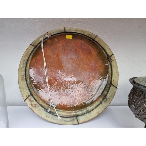 1159 - A 19th century Continental slip glazed charger, 44cm diameter.