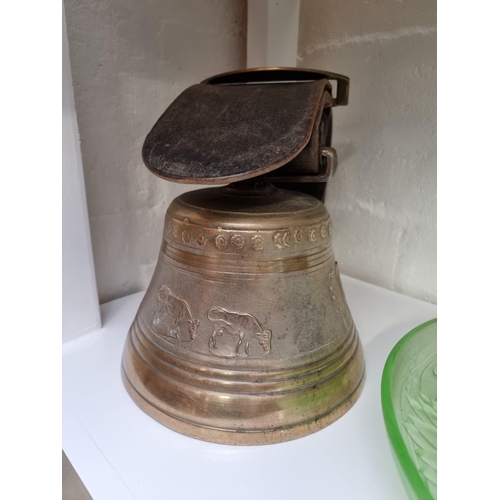 1166 - An old bronze cow bell, with thick leather strap and brass buckle, the bell 22.5cm diameter.... 