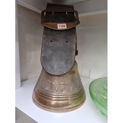 1166 - An old bronze cow bell, with thick leather strap and brass buckle, the bell 22.5cm diameter.... 