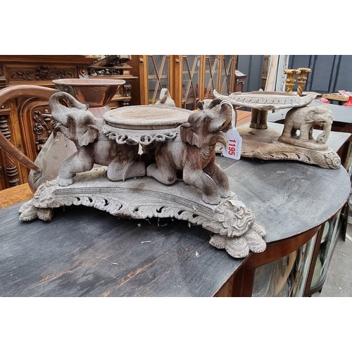 1195 - Two similar Balinese carved and weathered hardwood stands, each with elephant supports, 42cm wi... 