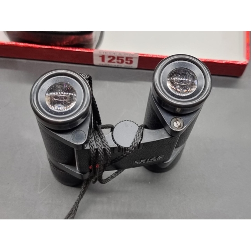 1255 - A pair of Leica 10x25 BC binoculars, in leather case.