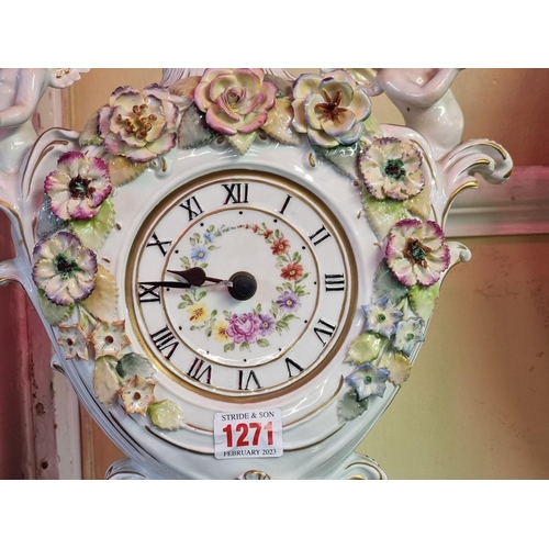 1271 - A large Dresden porcelain timepiece and stand, 52cm high, (associated battery movement).... 