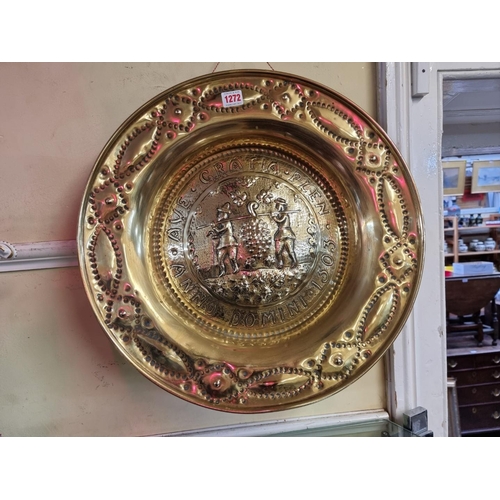 1272 - A Nuremberg brass alms dish, decorated with the Thieves or Spies of Canaan, inscribed and dated... 