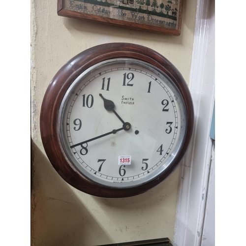 1315 - A mahogany wall clock, the 11 1/2in dial inscribed 'Smith, Enfield', with pendulum.  ... 