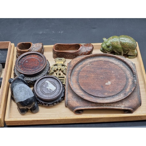 1332 - A mixed group of Chinese and Eastern items, to include ink stones, hardwood stands; and two carved h... 