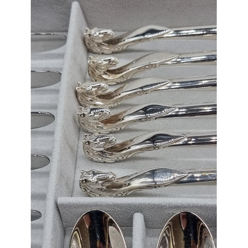 1337 - A canteen of electroplated cutlery, by Baigal, for six, with horse head terminals.   ... 