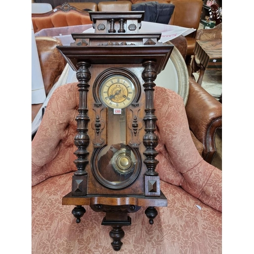 1355 - An antique walnut Vienna style wall clock, spring driven, 92cm high, with pendulum.